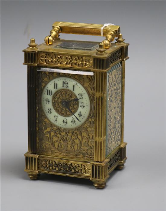 An ornate brass carriage timepiece